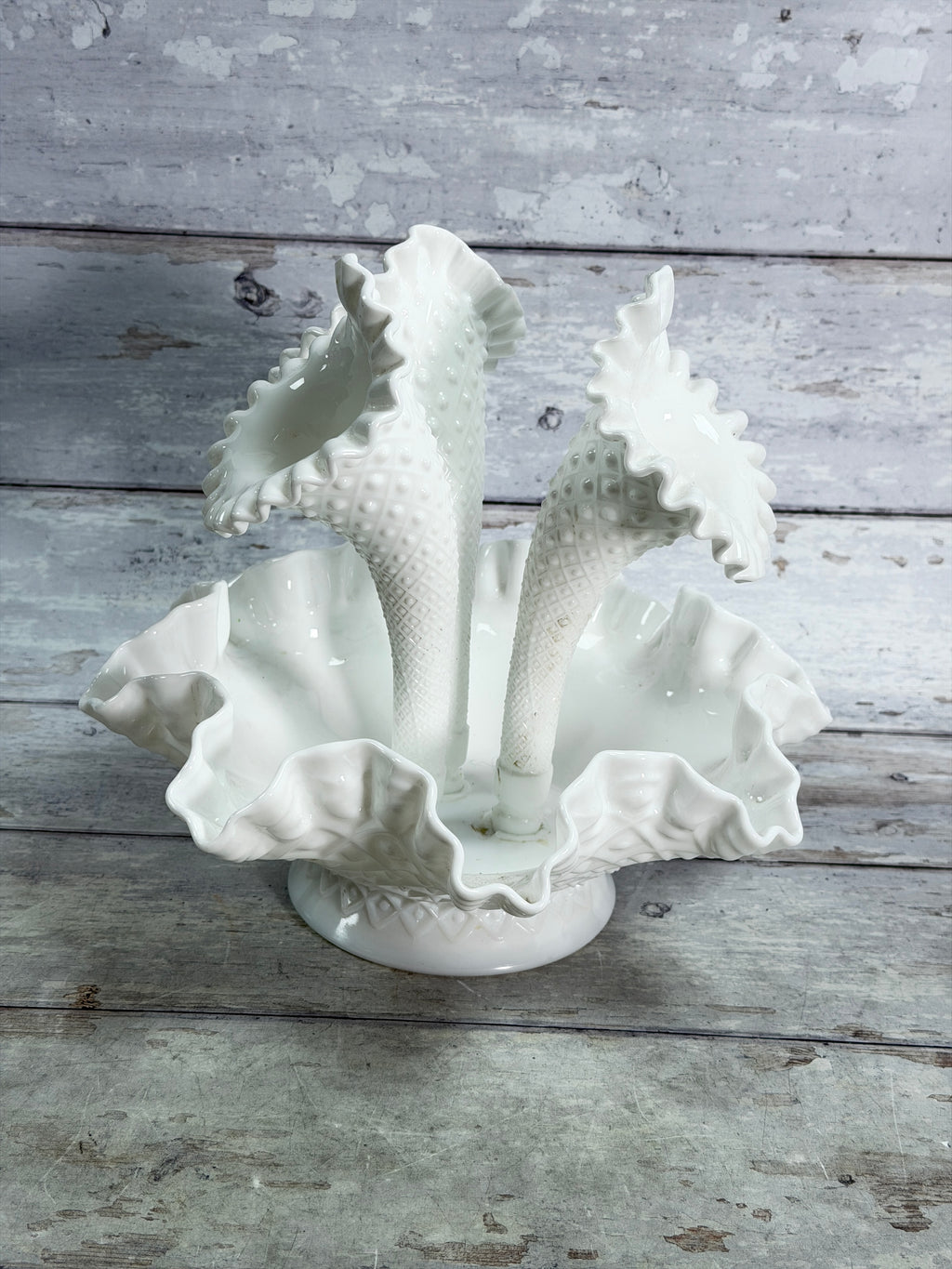 Angled view of three-horn milk glass epergne with diamond-lace detailing