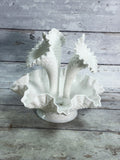 Angled view of three-horn milk glass epergne with diamond-lace detailing