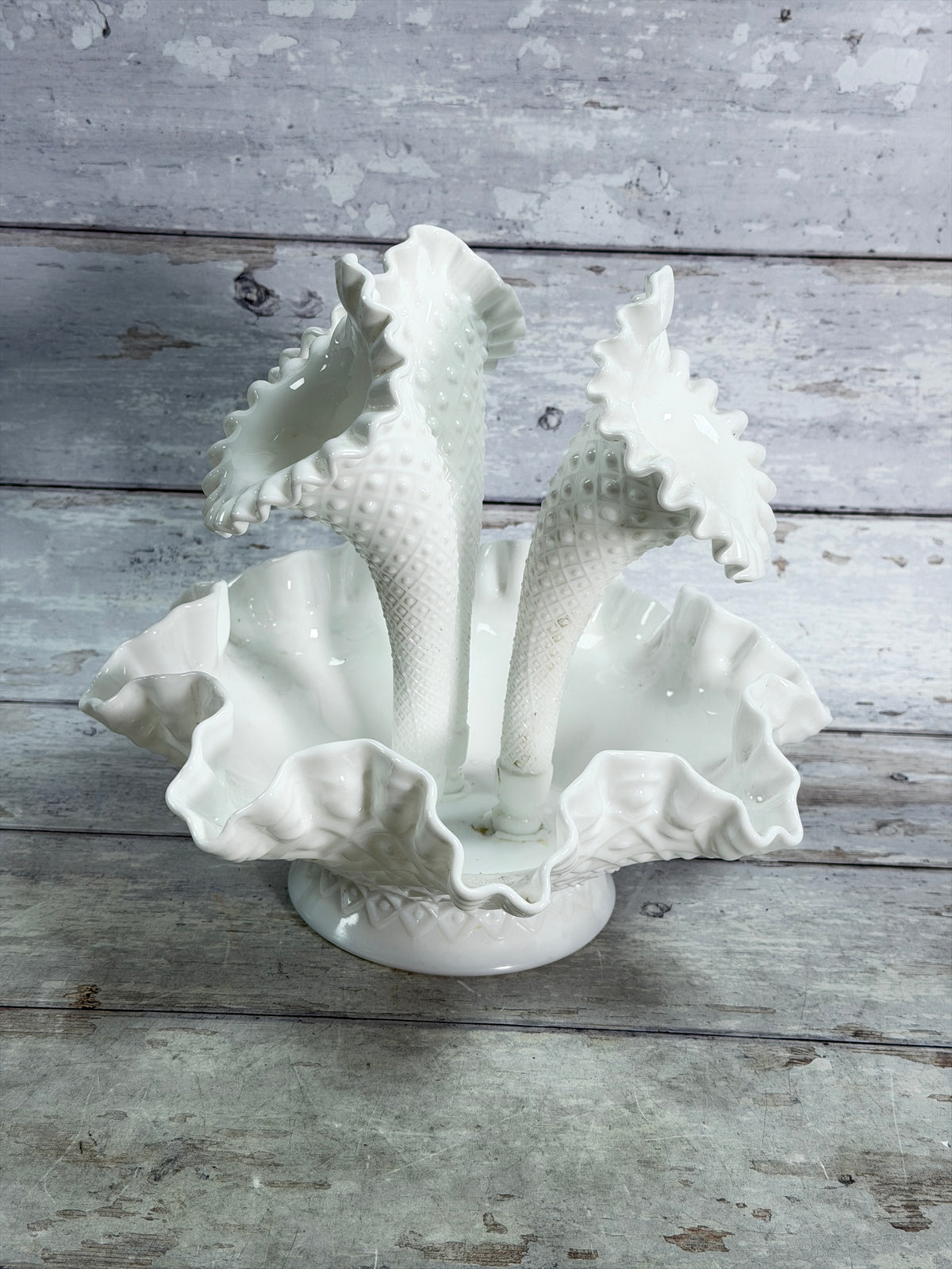 Angled view of three-horn milk glass epergne with diamond-lace detailing