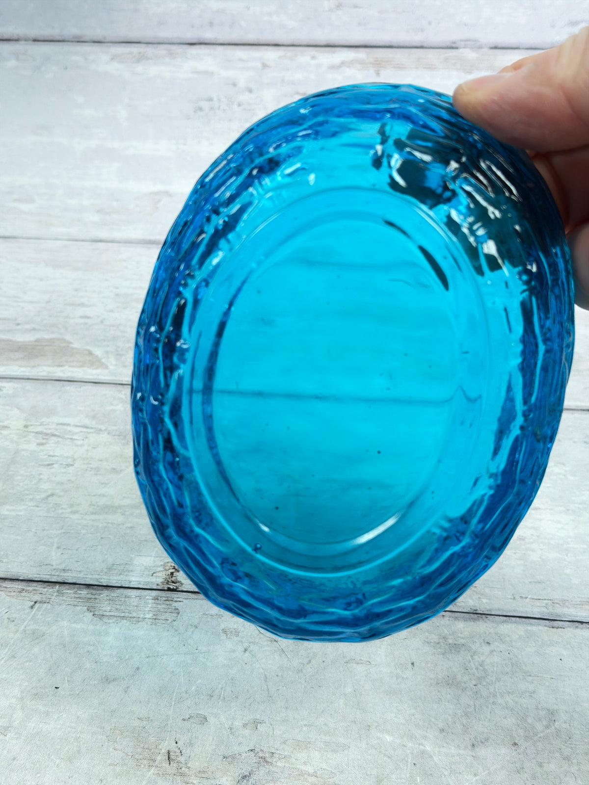 Blue glass dish lid with scalloped edge, rounded dish top view