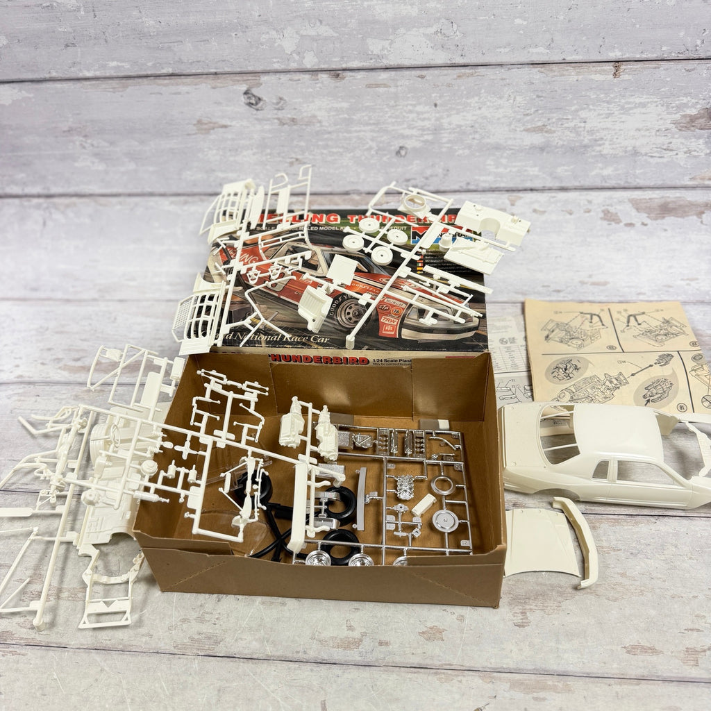 Open Monogram Melling Thunderbird kit with white and chrome parts and instructions