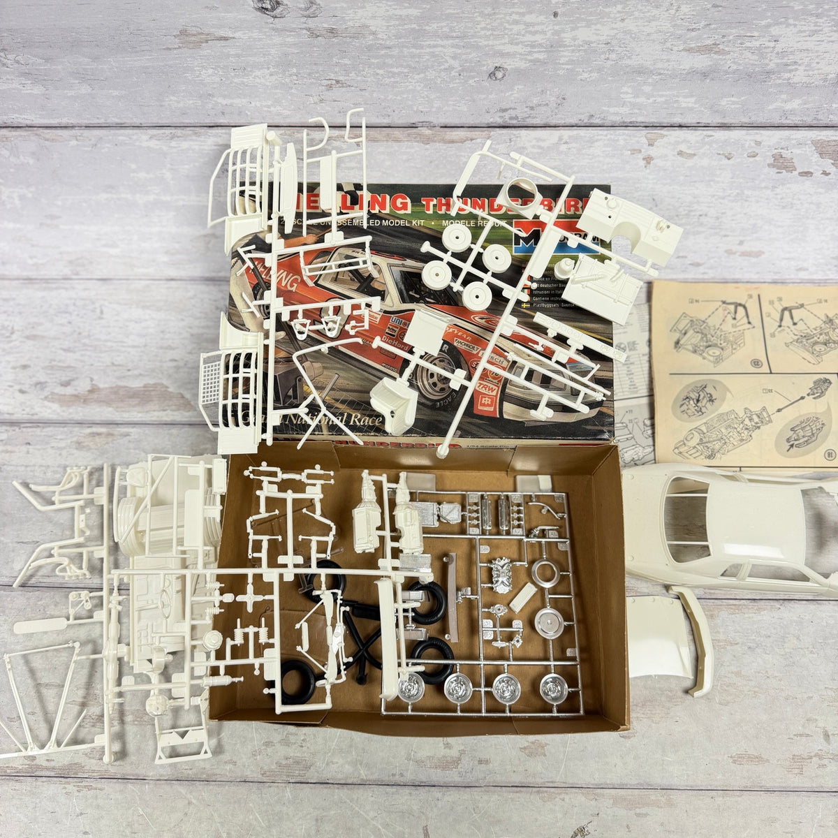 Overhead view of loose parts and sprues in Melling Thunderbird model kit