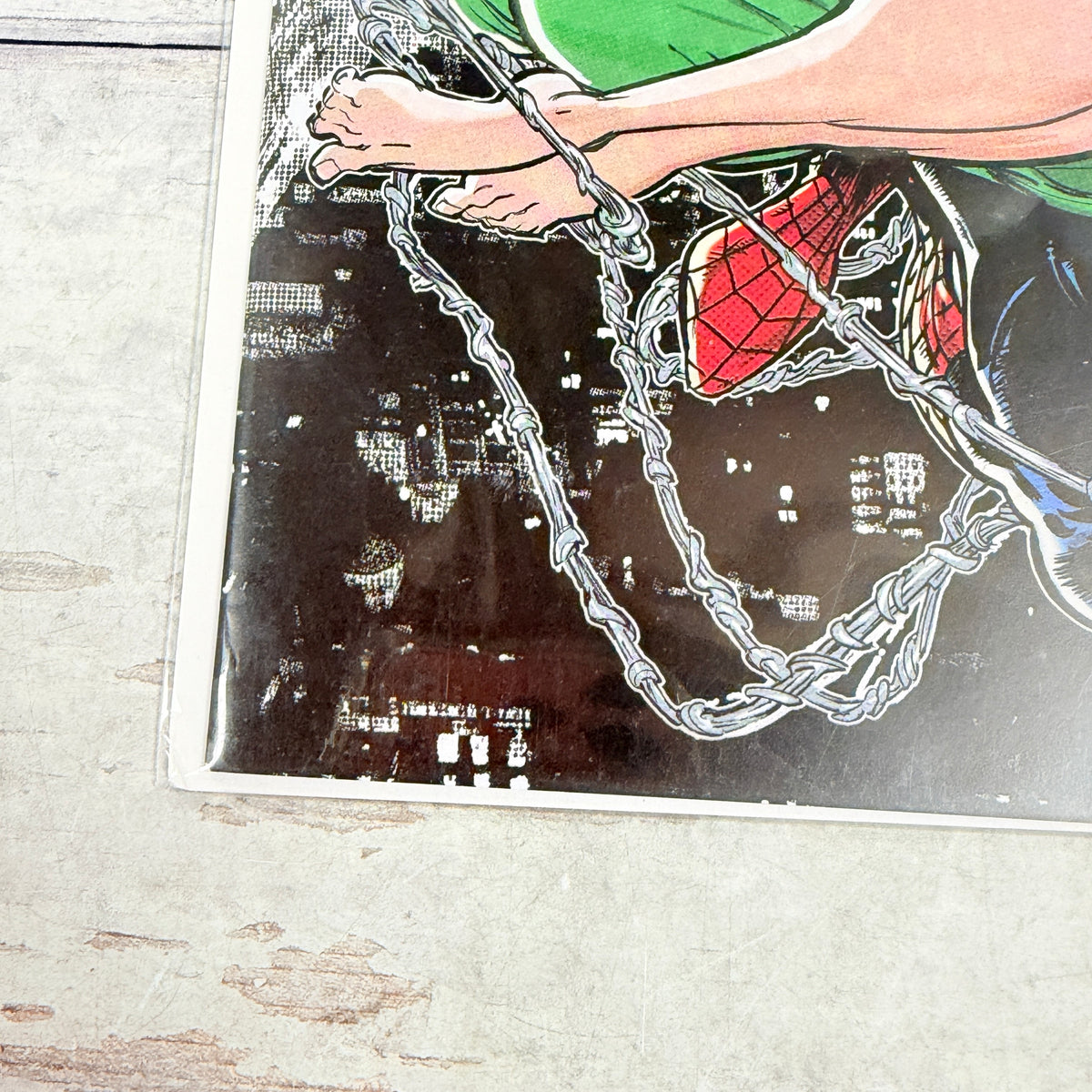 Amazing Spider-Man #28 (2023) Kaare Andrews Virgin Variant, lower-left cover detail in clear sleeve