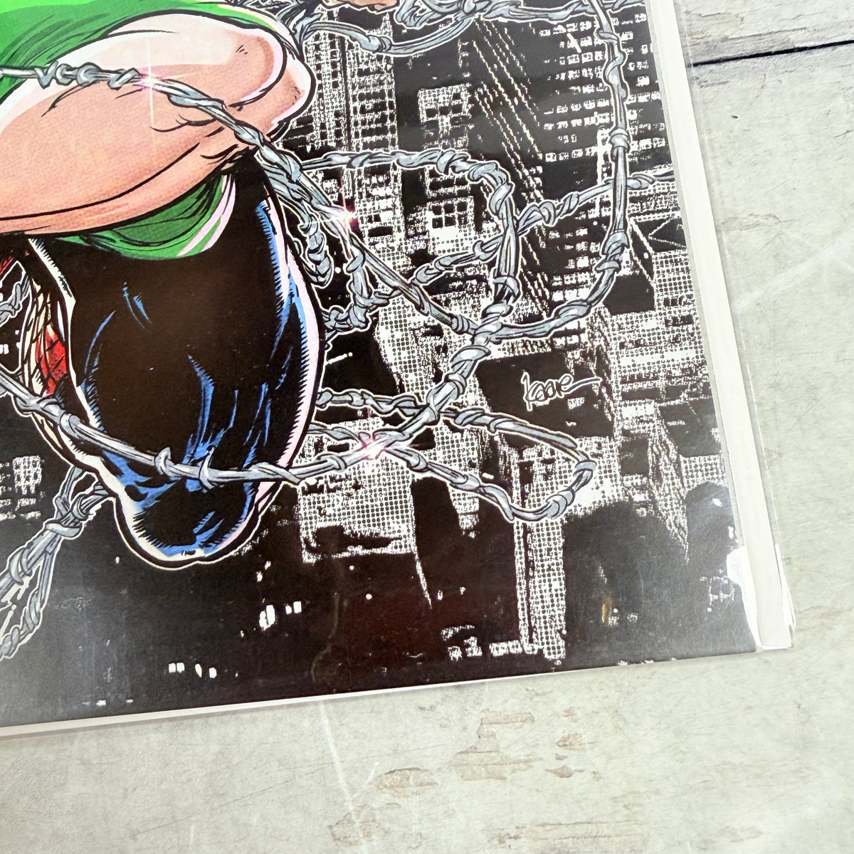 Amazing Spider-Man #28 (2023) Kaare Andrews Virgin Variant, lower-right cover detail in clear sleeve