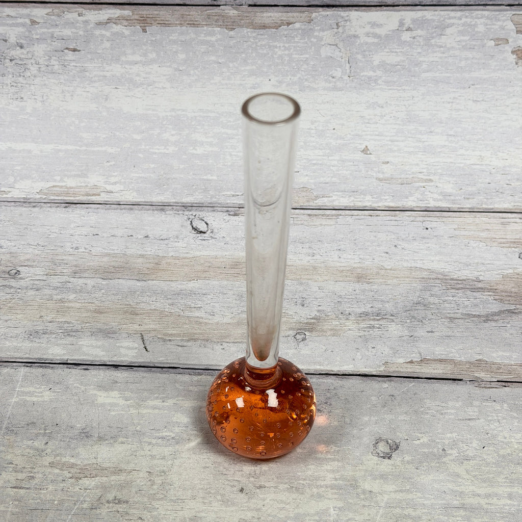 Angled view of long-neck glass bud vase and rose-amber bubble base