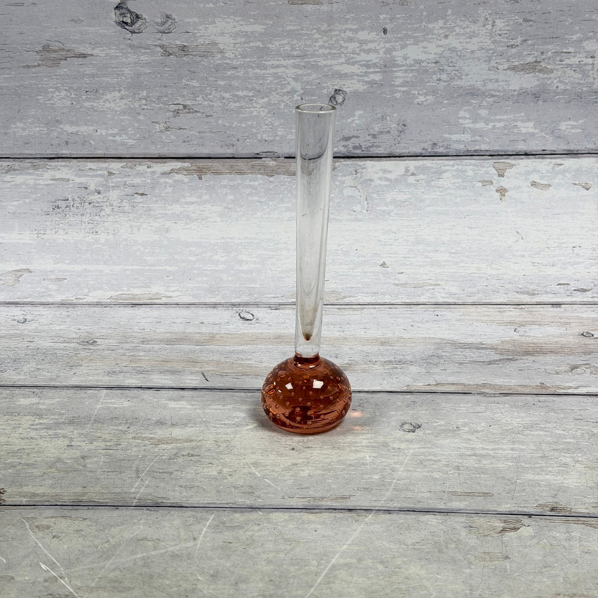 Rose-amber controlled-bubble glass bud vase with long clear neck, front view