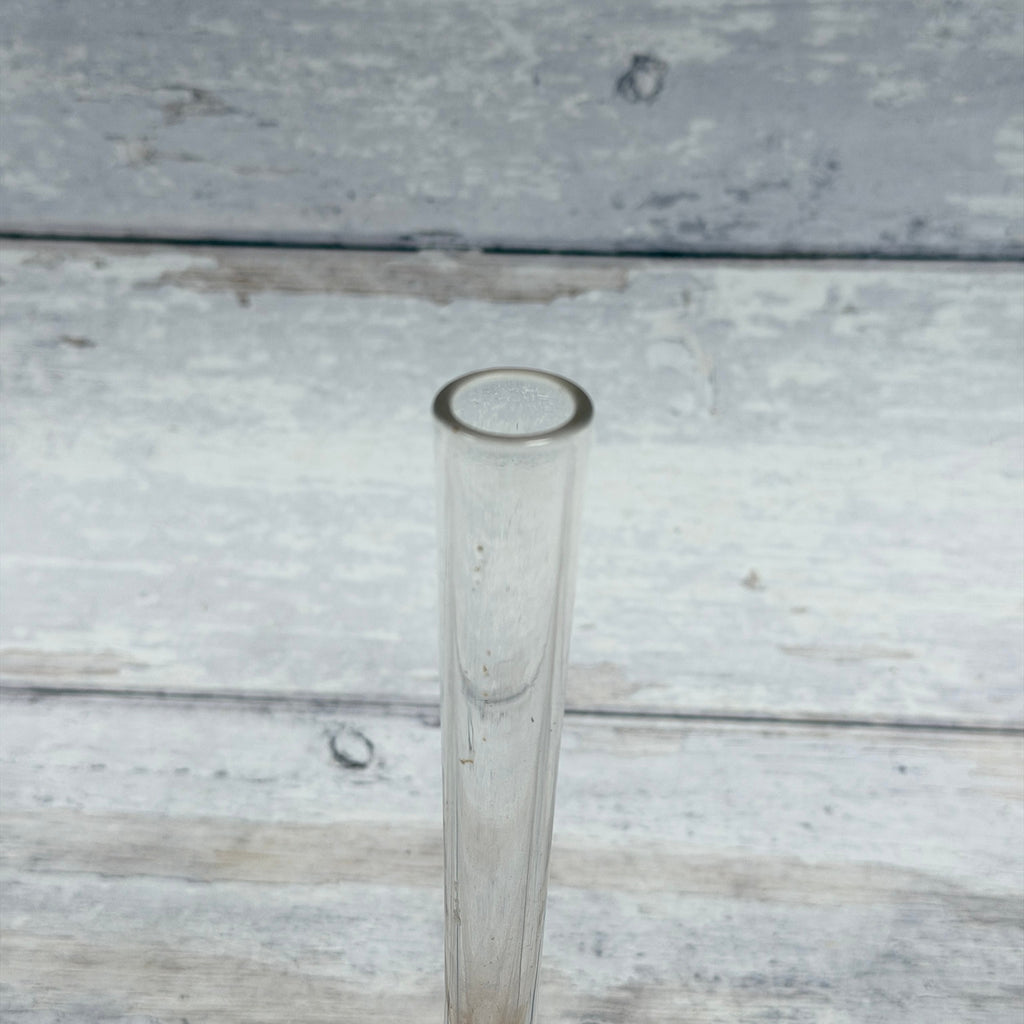 Close-up of circular glass rim and clear neck with visible interior discoloration