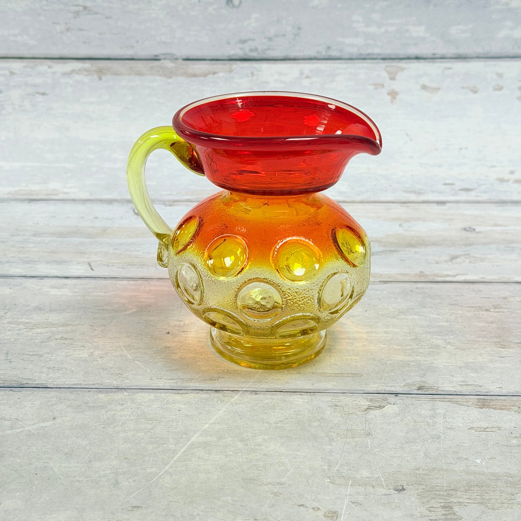 Amberina thumbprint miniature glass pitcher with red rim and yellow applied handle