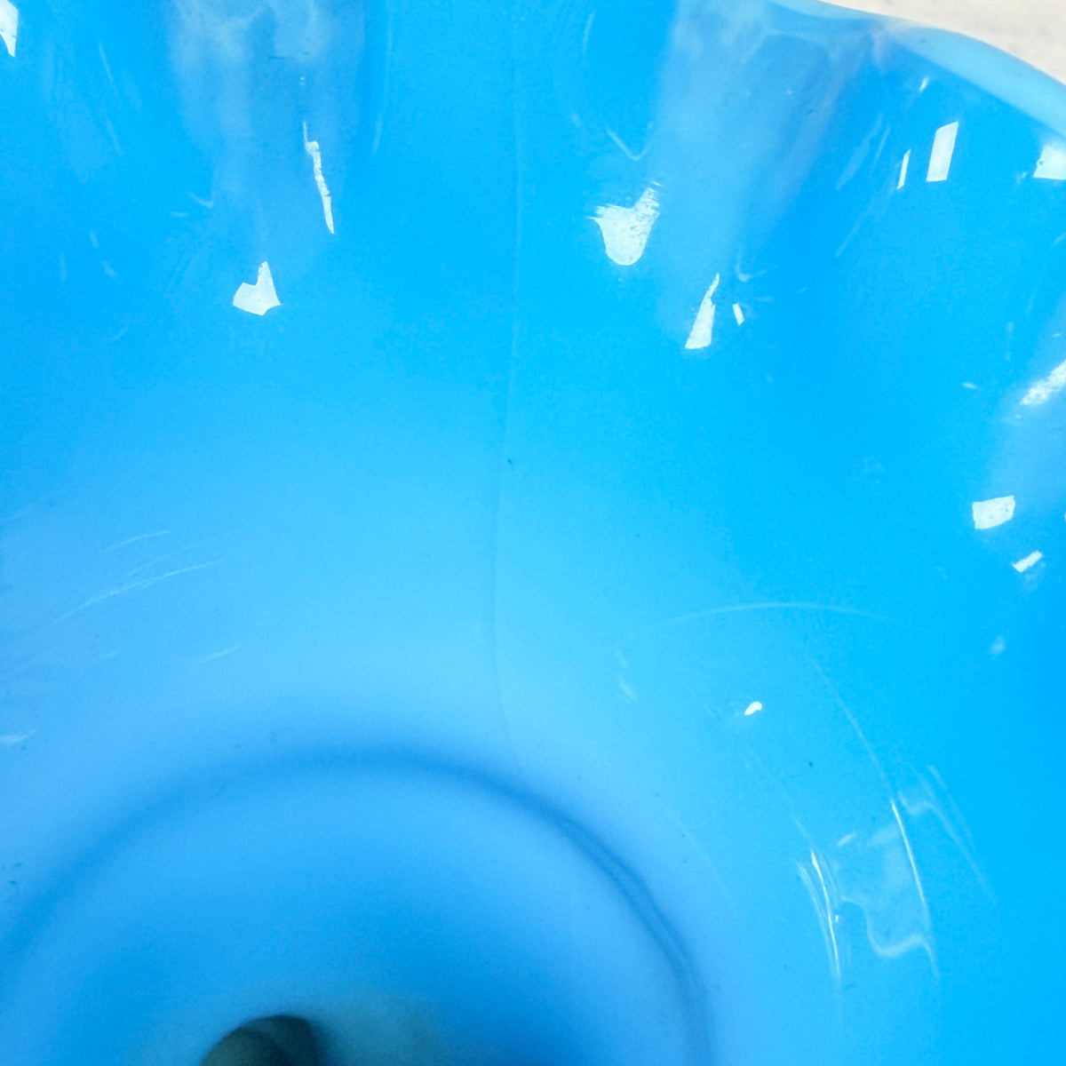 Interior view of blue glass vase showing the hairline crack