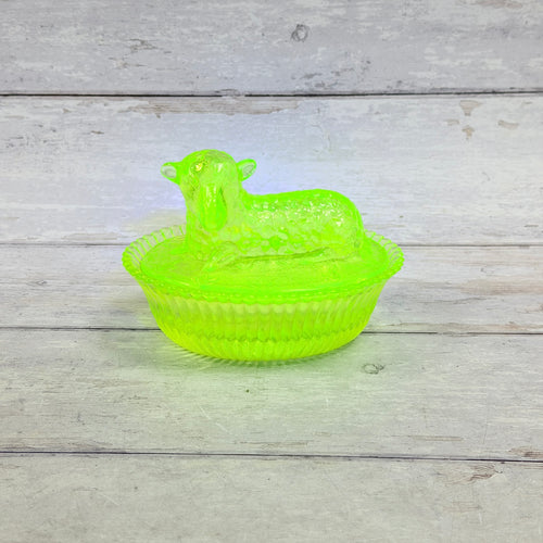 Boyd vaseline glass lamb on nest dish glowing bright green under UV light