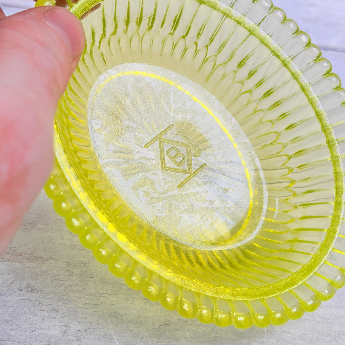 Interior of Boyd vaseline glass lamb on nest dish showing glass detail