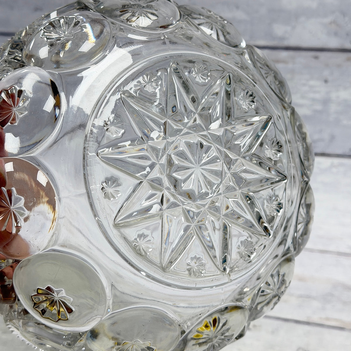 Underside of clear Moon and Star bowl with large geometric star and small rosette details
