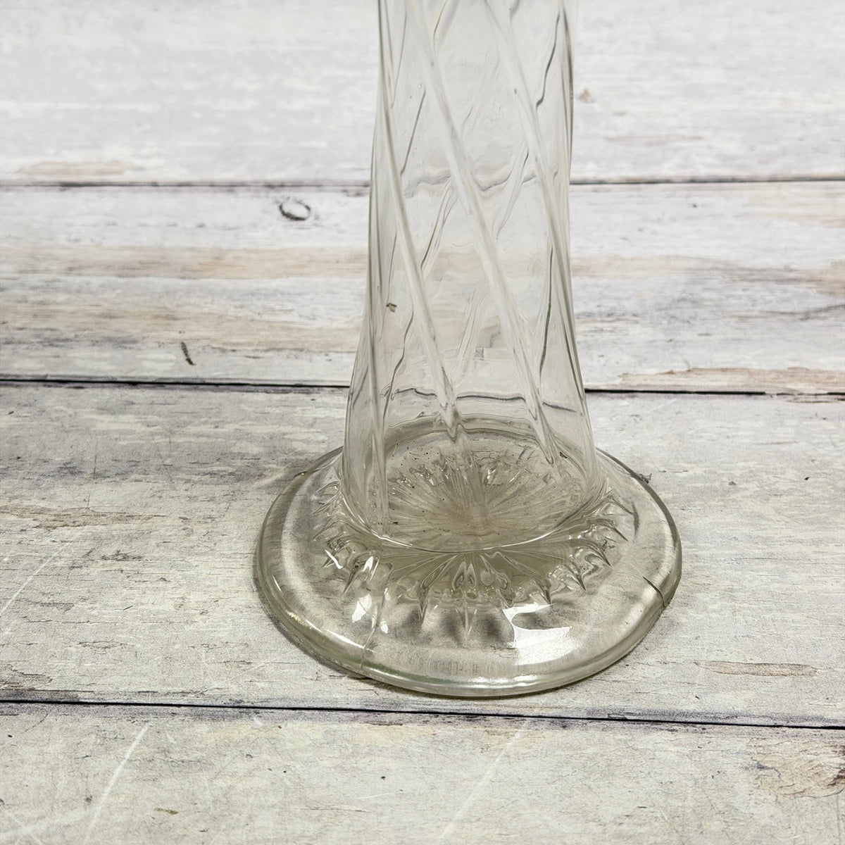 Round foot with molded star detail and visible surface line at the right edge