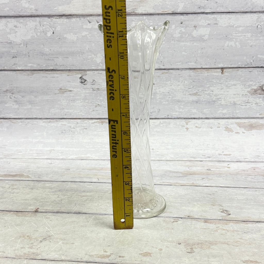 Clear twisted-rib glass vase beside an inch ruler showing approximate height