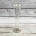 Clear twisted-rib glass vase with eight-point ruffled rim and round foot, front view