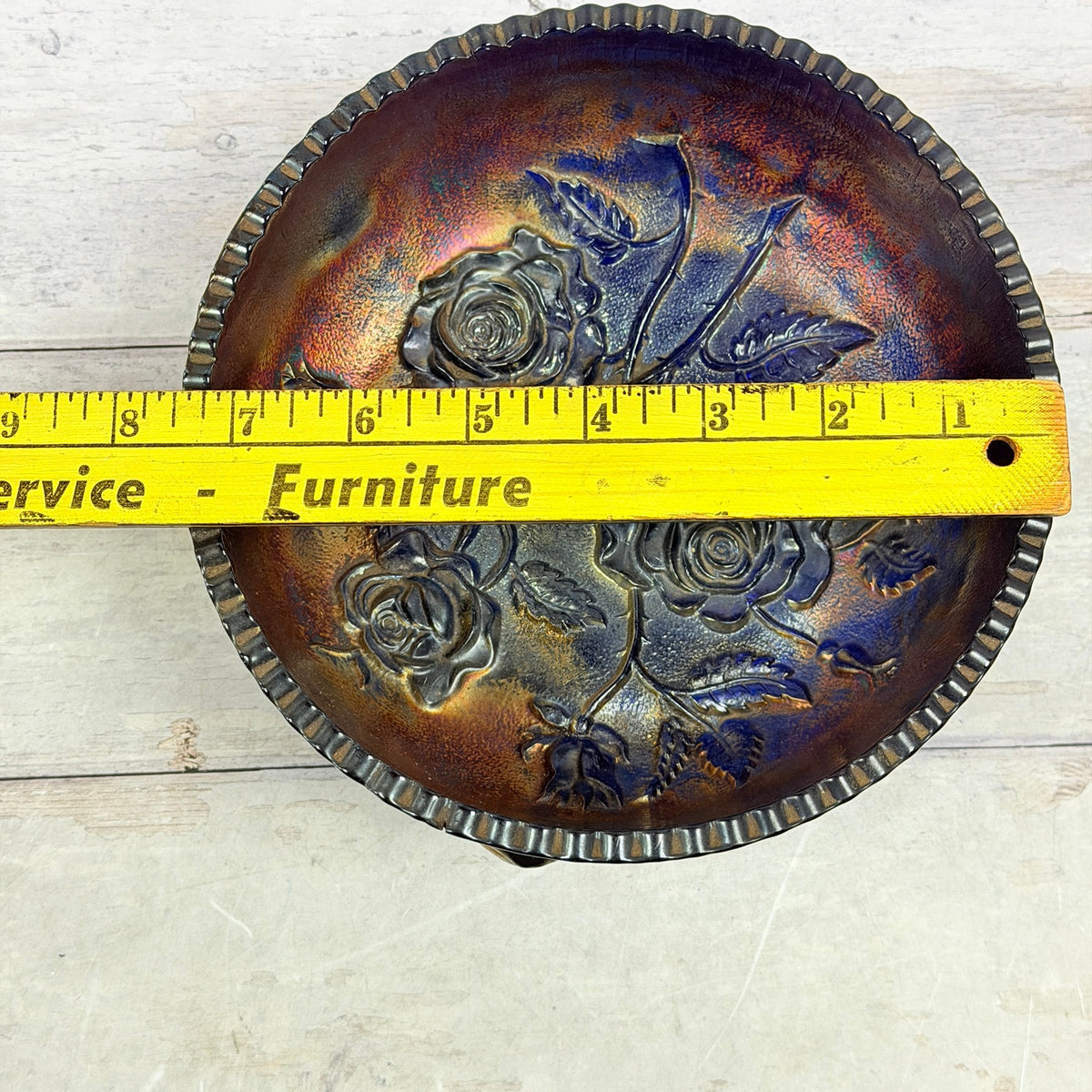 Cobalt rose-pattern carnival glass bowl with ruler showing approximate diameter