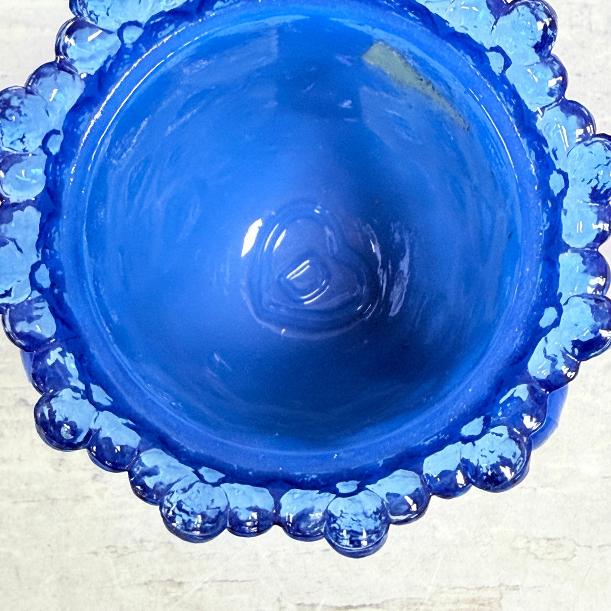 Interior D-in-heart Degenhart mark and old label residue in blue glass toothpick holder