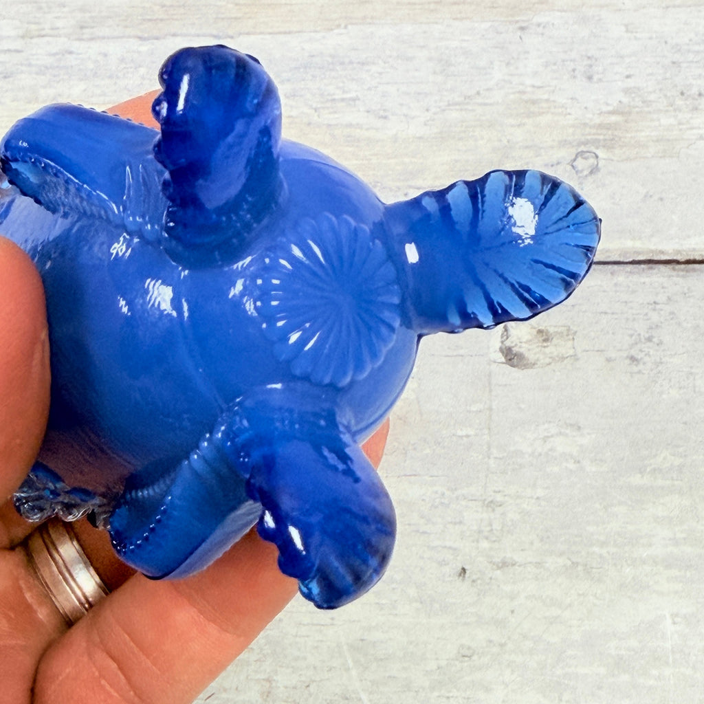 Underside of Degenhart blue toothpick holder showing three molded feet