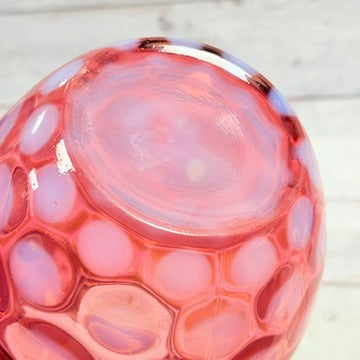 Underside of cranberry opalescent glass pitcher