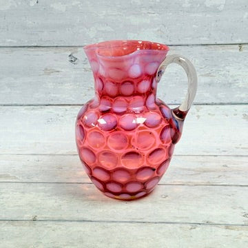 Reverse view of Fenton cranberry coin dot pitcher