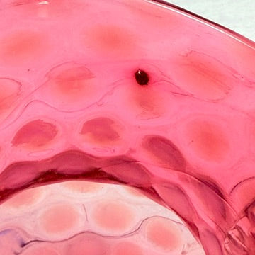 Small nodule beneath interior rim of Fenton cranberry pitcher