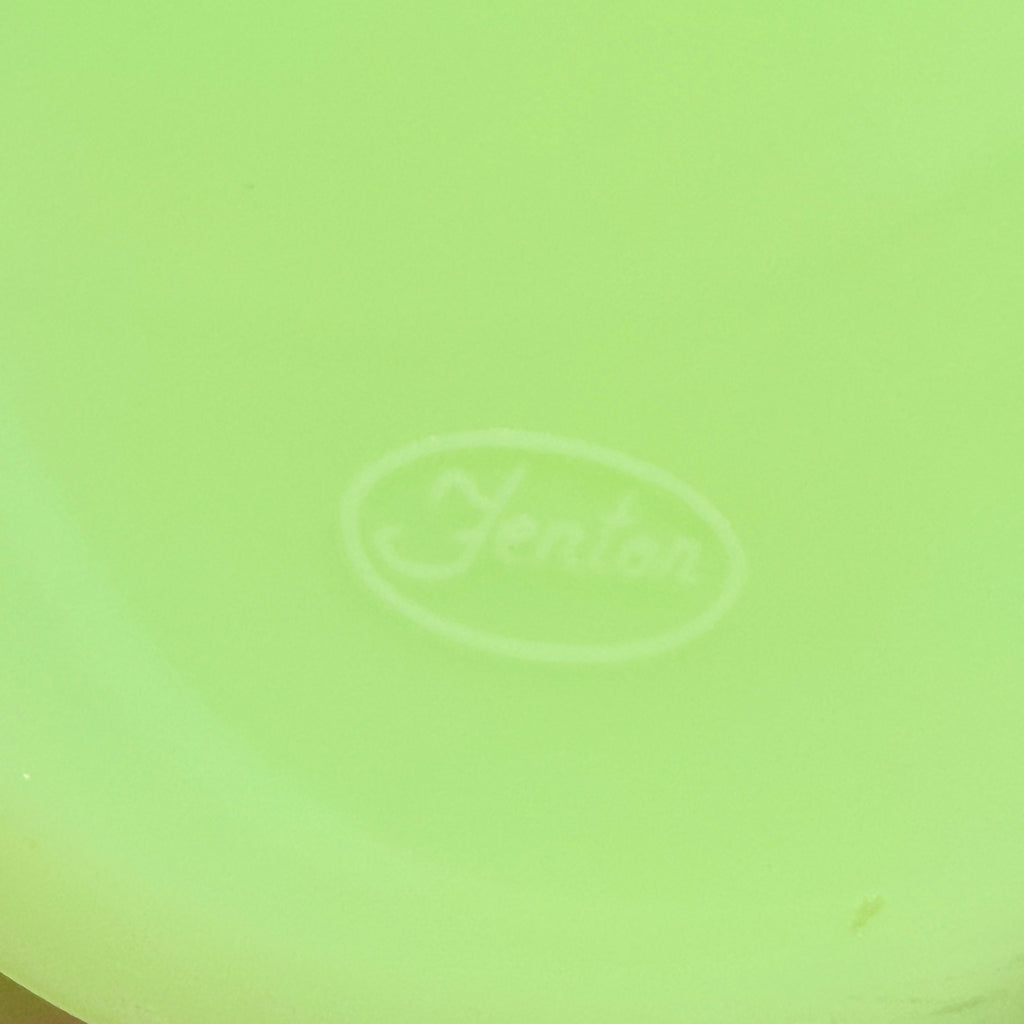 Close-up of molded oval Fenton maker mark on satin glass jar