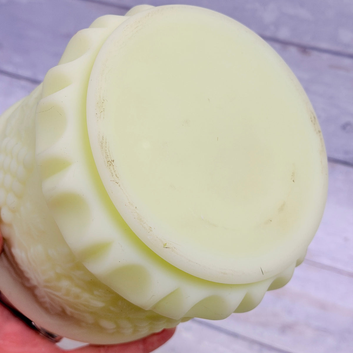 Underside of Fenton custard satin tobacco jar showing base wear