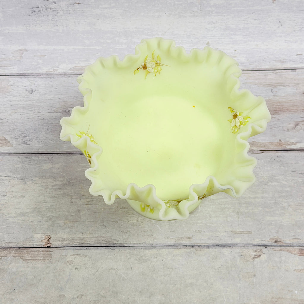 Top view of the ruffled custard glass compote showing painted daisies, rim scuffs and small surface marks