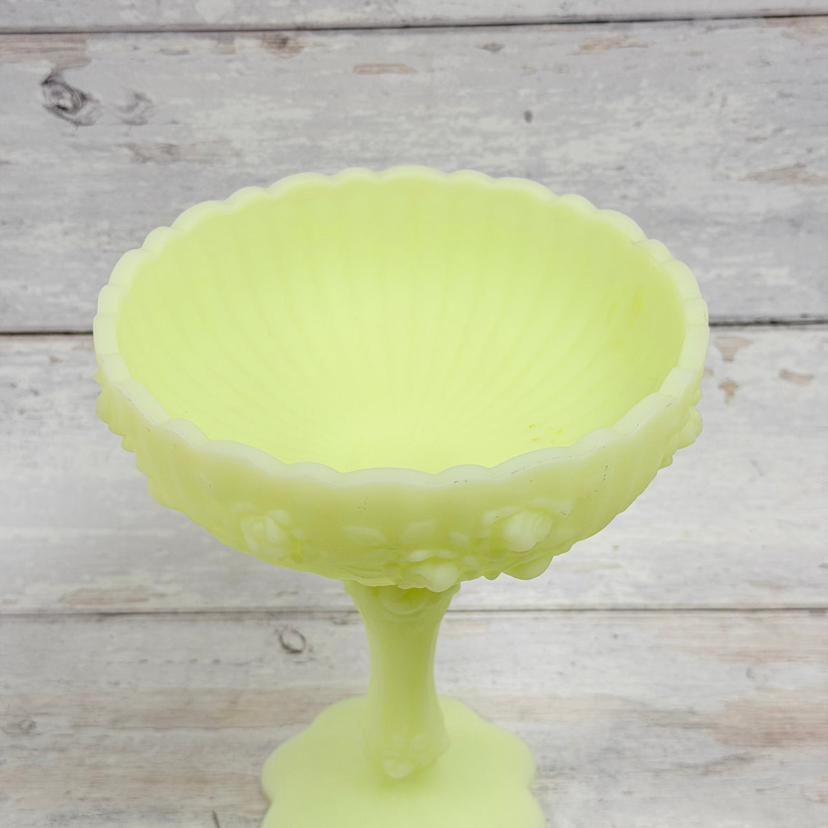 Top view of Fenton Cabbage Rose compote showing the scalloped rim, gray surface scuffs and small amber interior marks