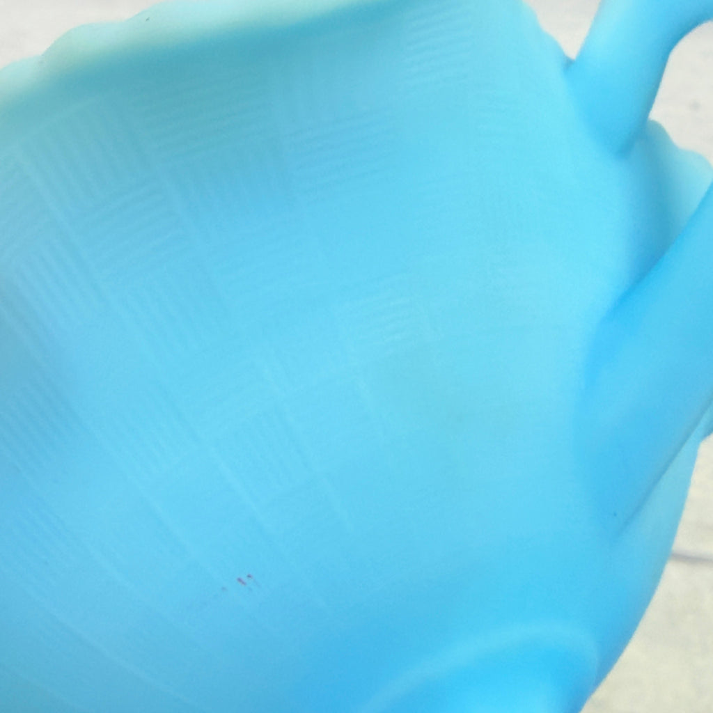 Close-up of blue satin glass texture and visible surface marks on Fenton handled compote