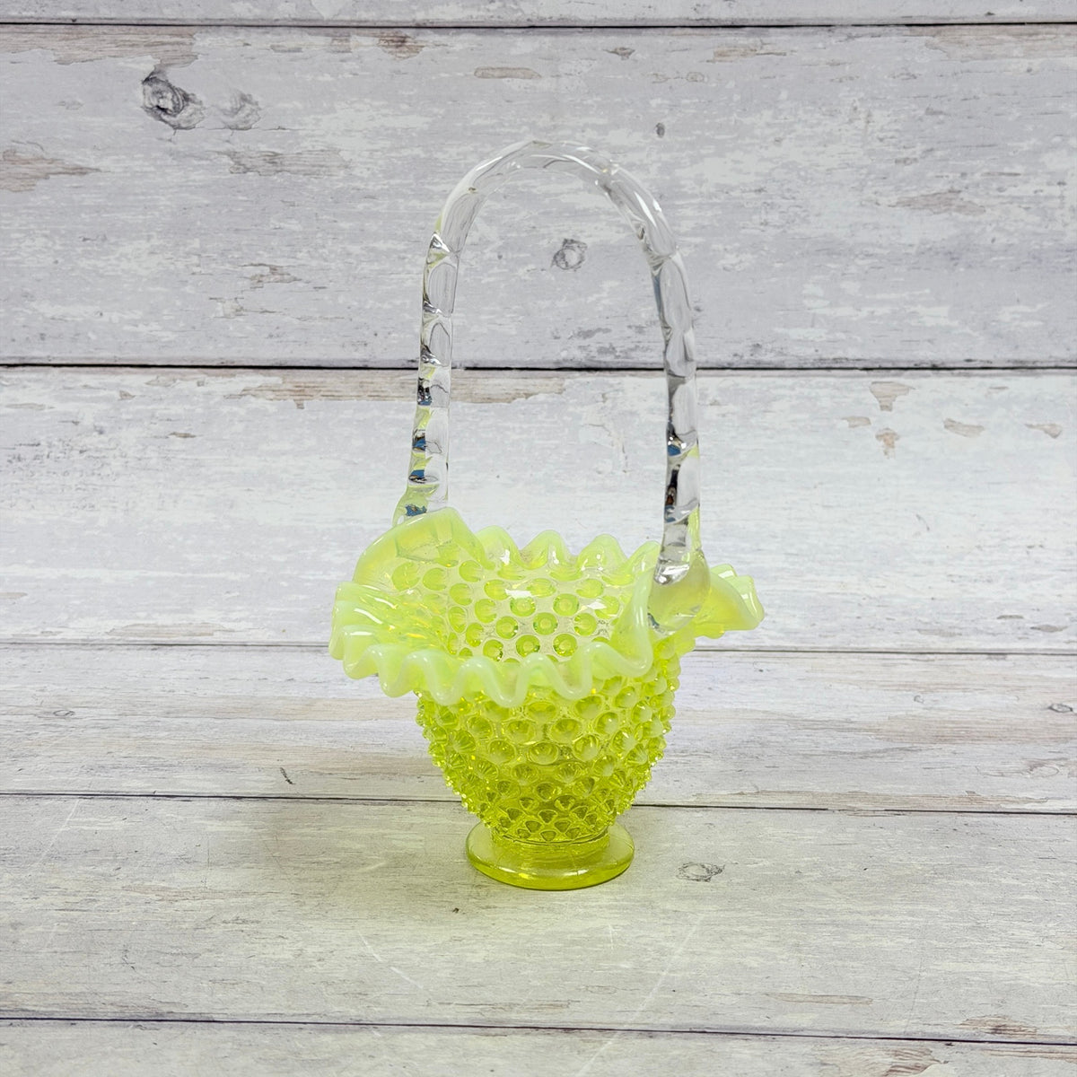 Fenton topaz opalescent hobnail glass basket with ruffled rim and clear applied handle