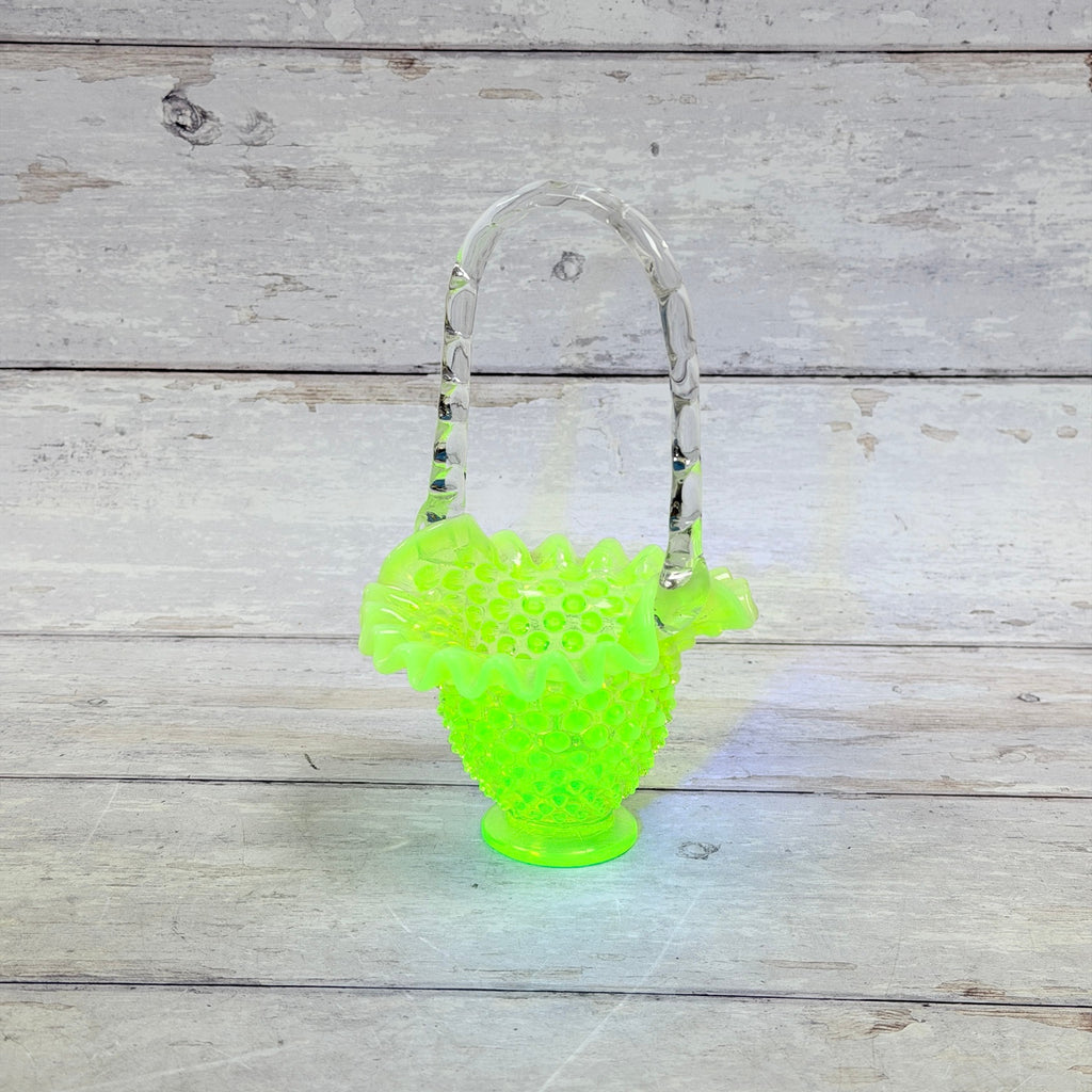 Fenton topaz hobnail Vaseline glass basket showing bright green fluorescence under UV light