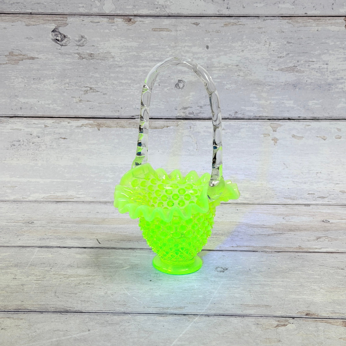 Fenton topaz hobnail Vaseline glass basket showing bright green fluorescence under UV light