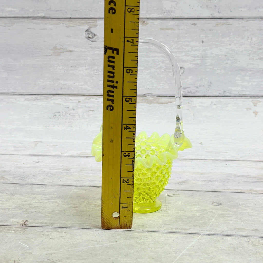 Fenton topaz hobnail basket beside ruler showing approximately seven-inch overall height