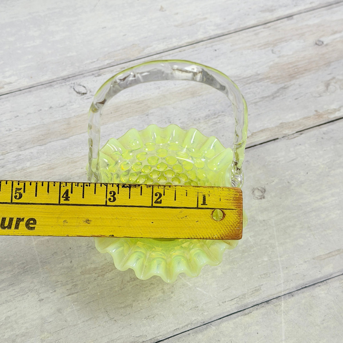 Fenton topaz hobnail basket with ruler across ruffled opening