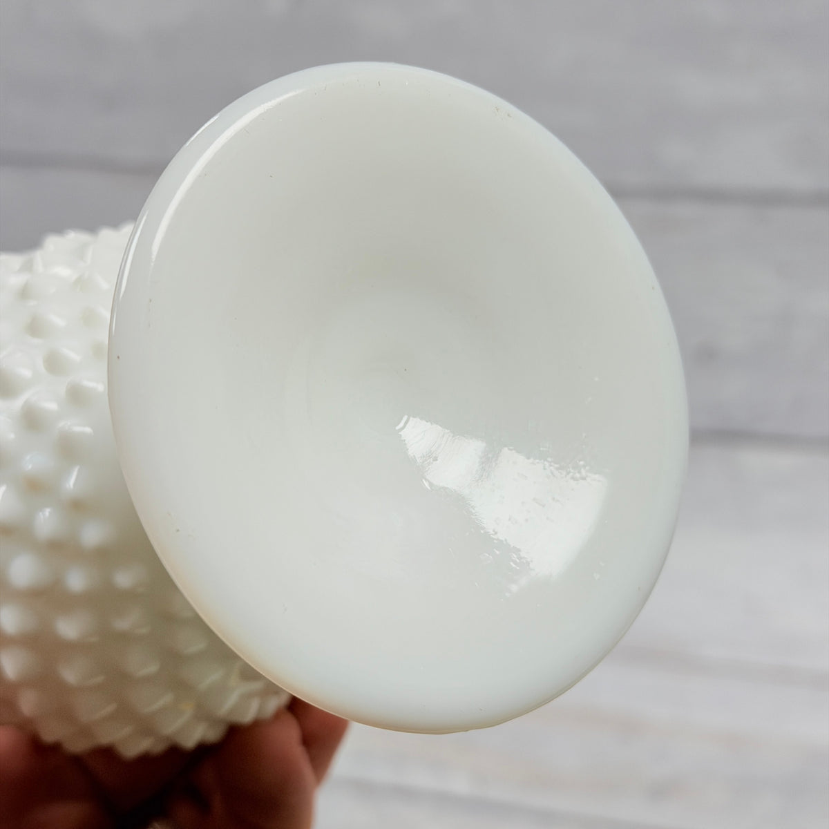 Unmarked underside of Fenton white milk glass footed swung vase