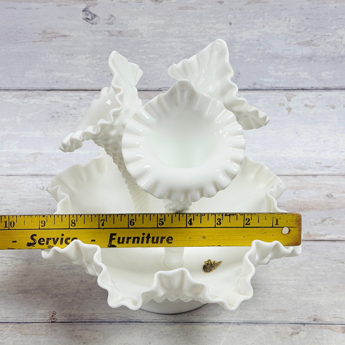 Ruler view of Fenton milk glass epergne showing approximate nine-inch width
