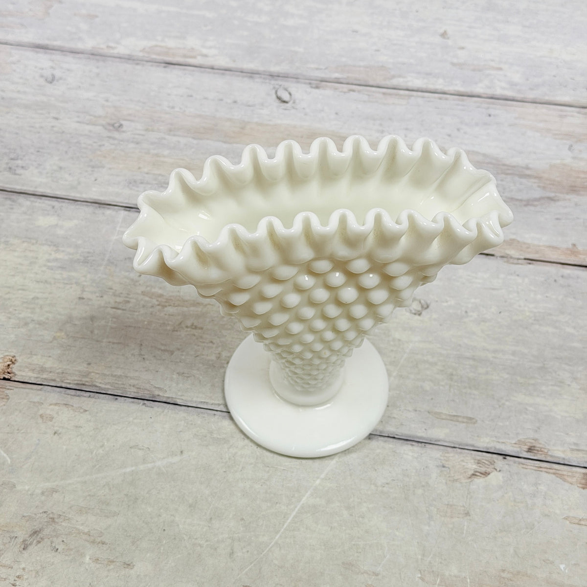 Crimped rim of Fenton-attributed white Hobnail fan vase showing pale tan discoloration