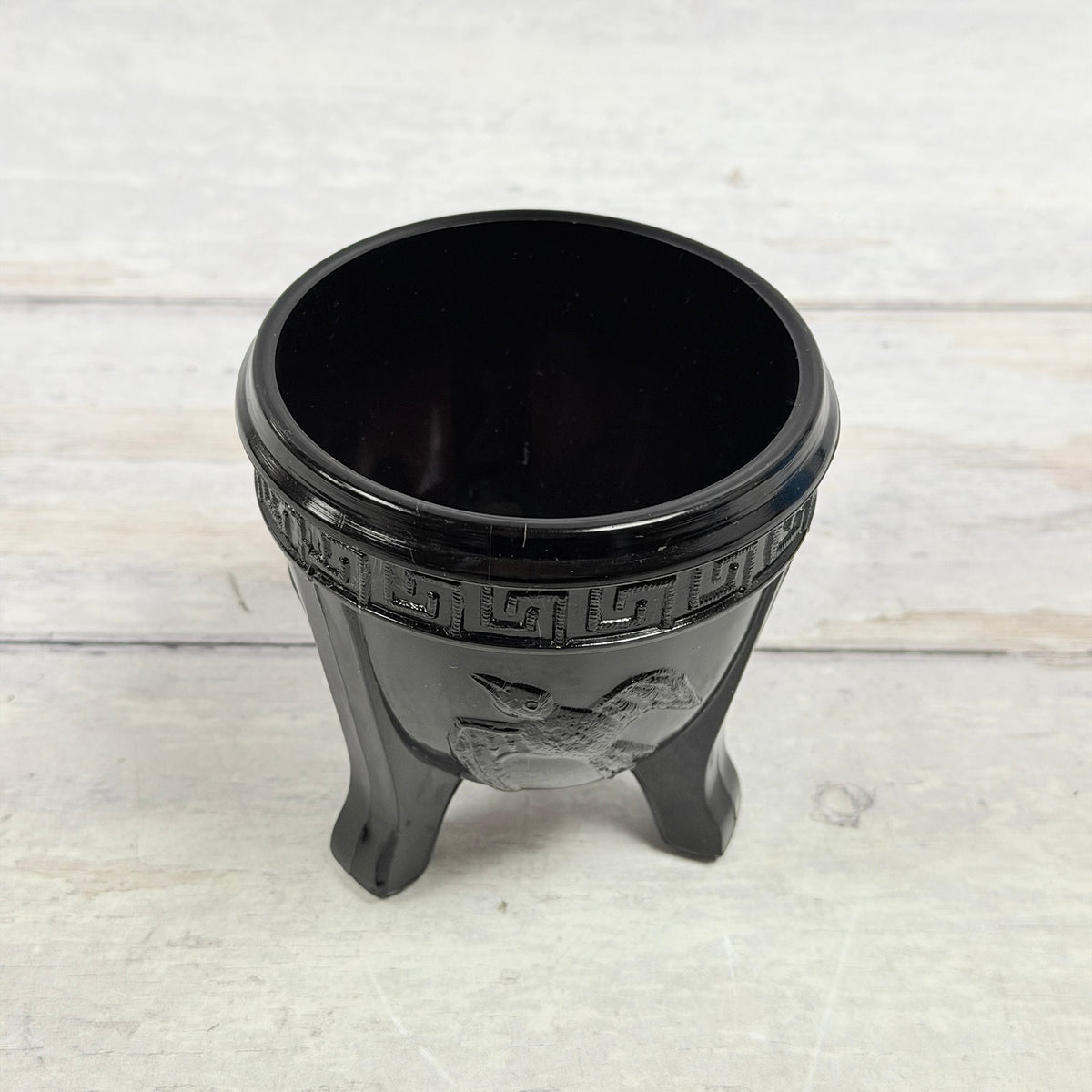 Upper view of black amethyst bird bowl showing interior and rim surface scratches