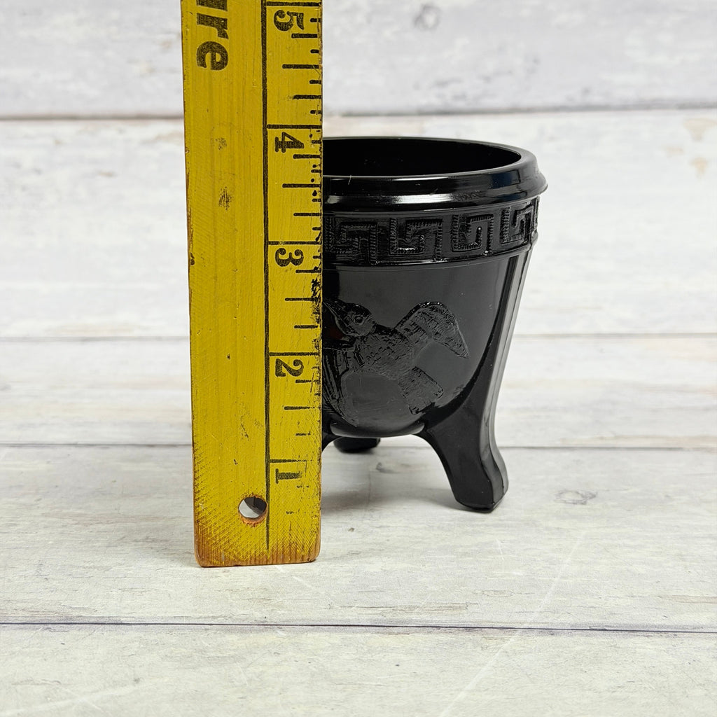 Small black amethyst bird bowl beside ruler showing approximately three and three-quarter inches in height