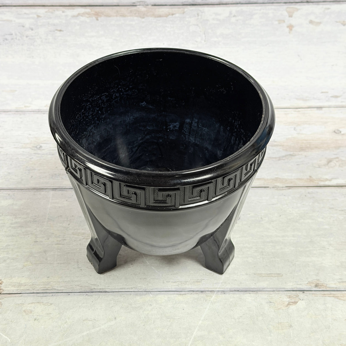 Interior of black amethyst Greek Key fern bowl showing cloudy surface wear and scratches