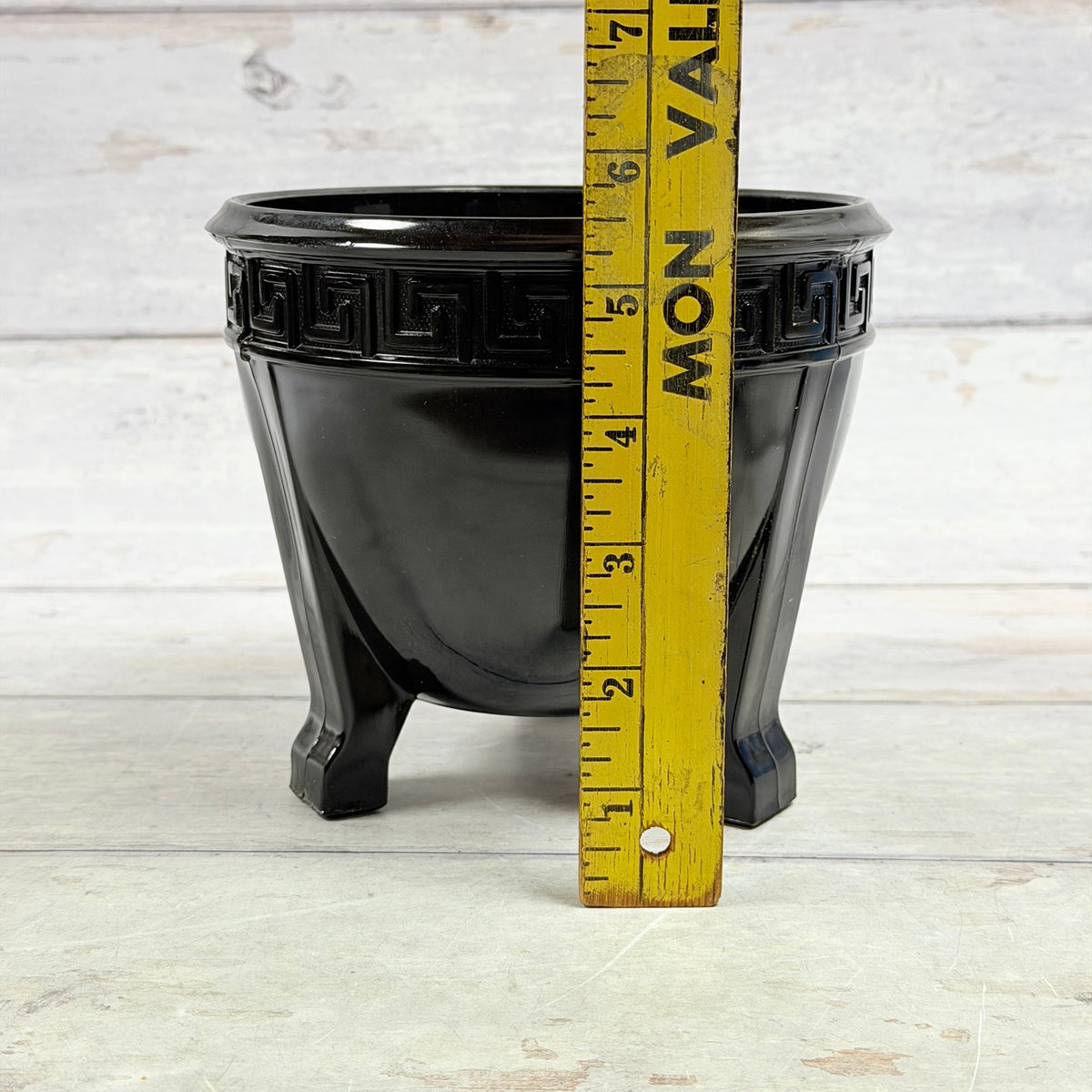 Black amethyst Greek Key footed fern bowl beside ruler showing height