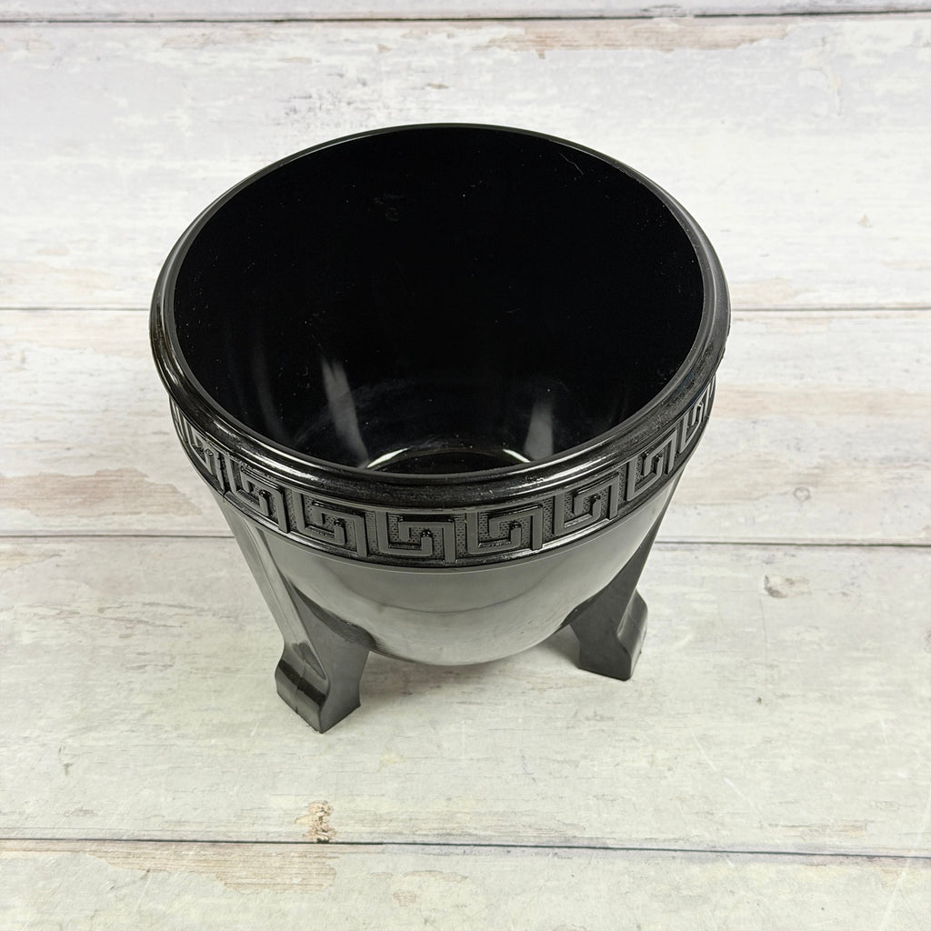 Interior and Greek Key rim of black amethyst three-footed glass fern bowl showing surface wear