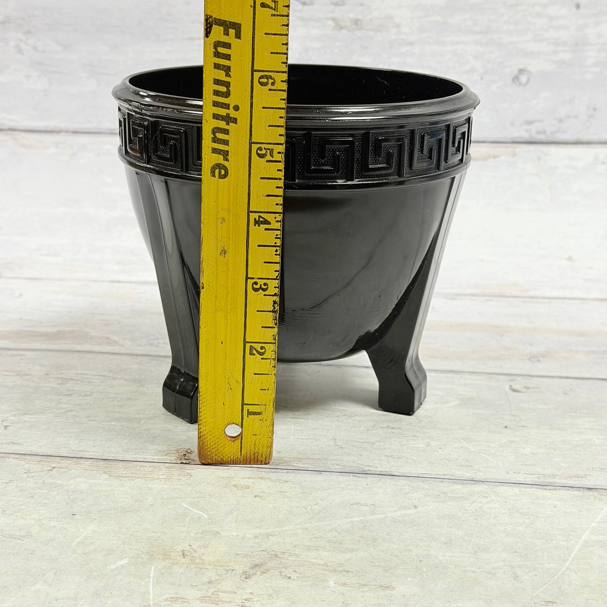 Black amethyst Greek Key footed fern bowl beside ruler showing height