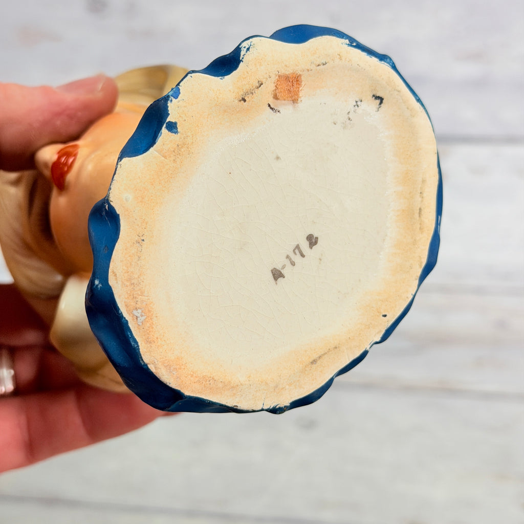 Underside of lady head vase showing A-172 mark and base wear