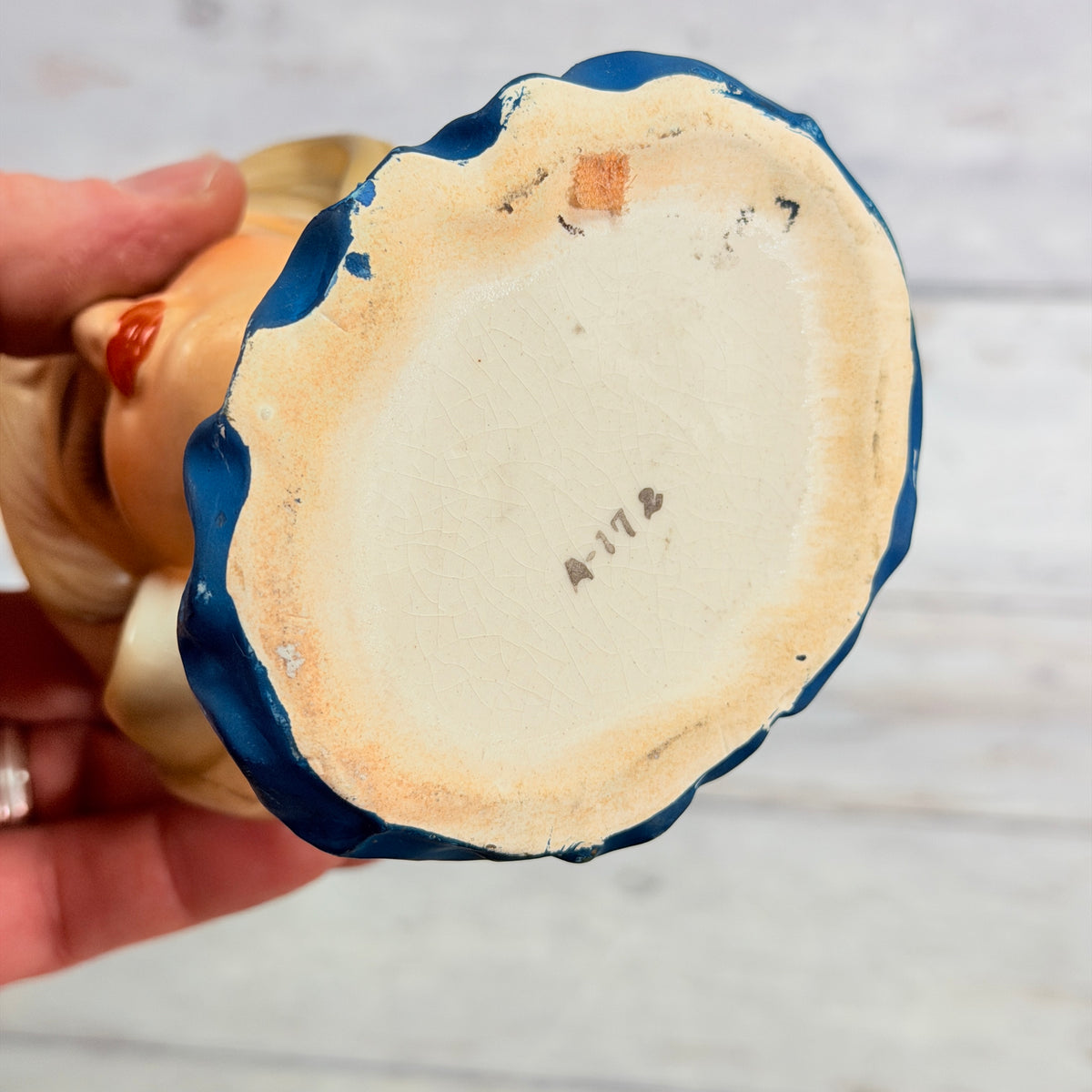 Underside of lady head vase showing A-172 mark and base wear