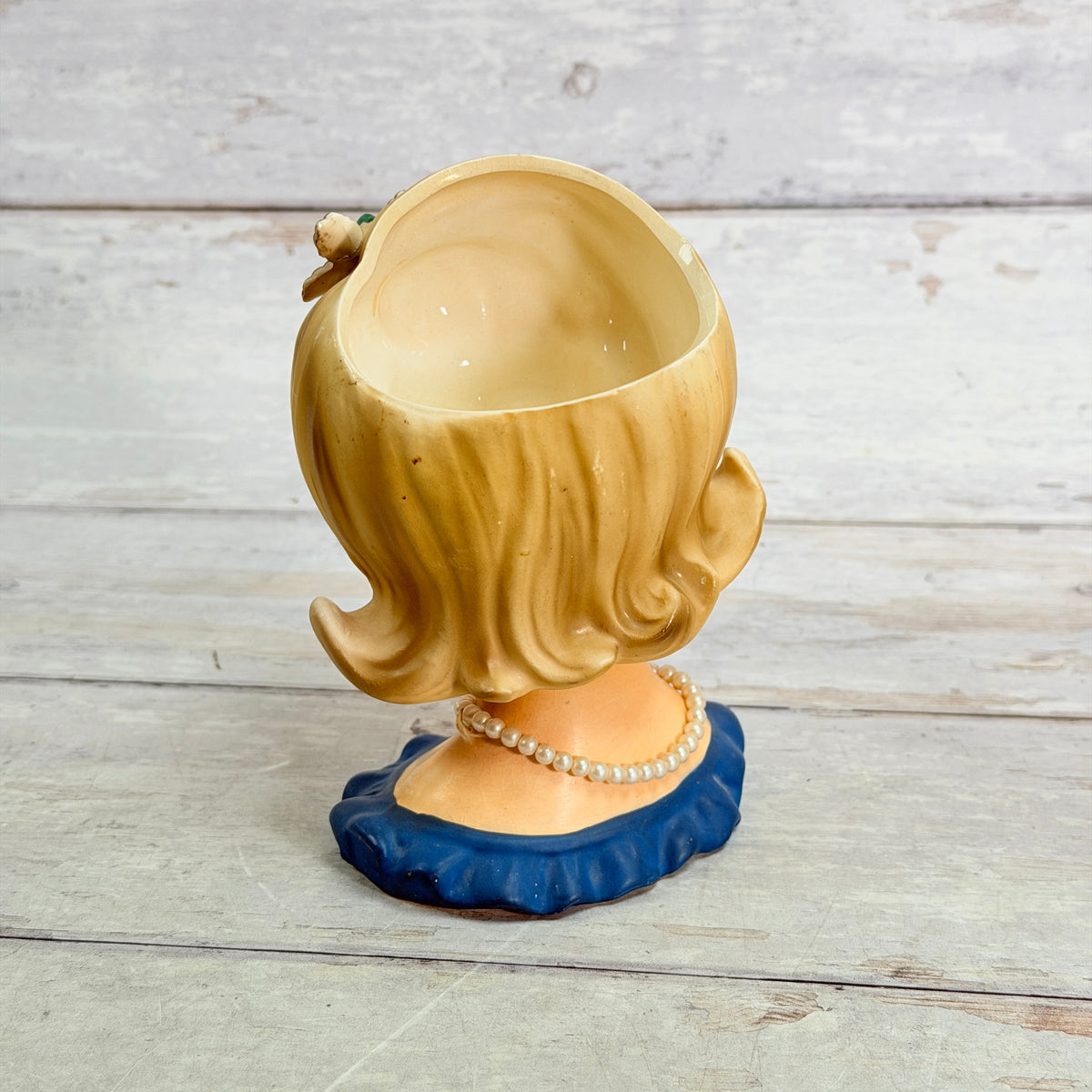 Rear view of blonde flip hairstyle and open vase interior