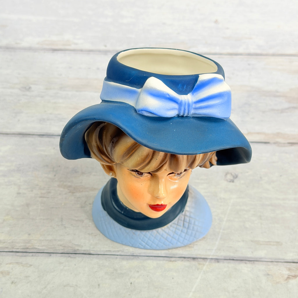 Top view of blue hat with bow and vase opening