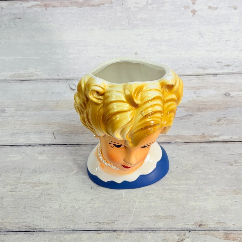 Top view of head vase opening and blonde curls