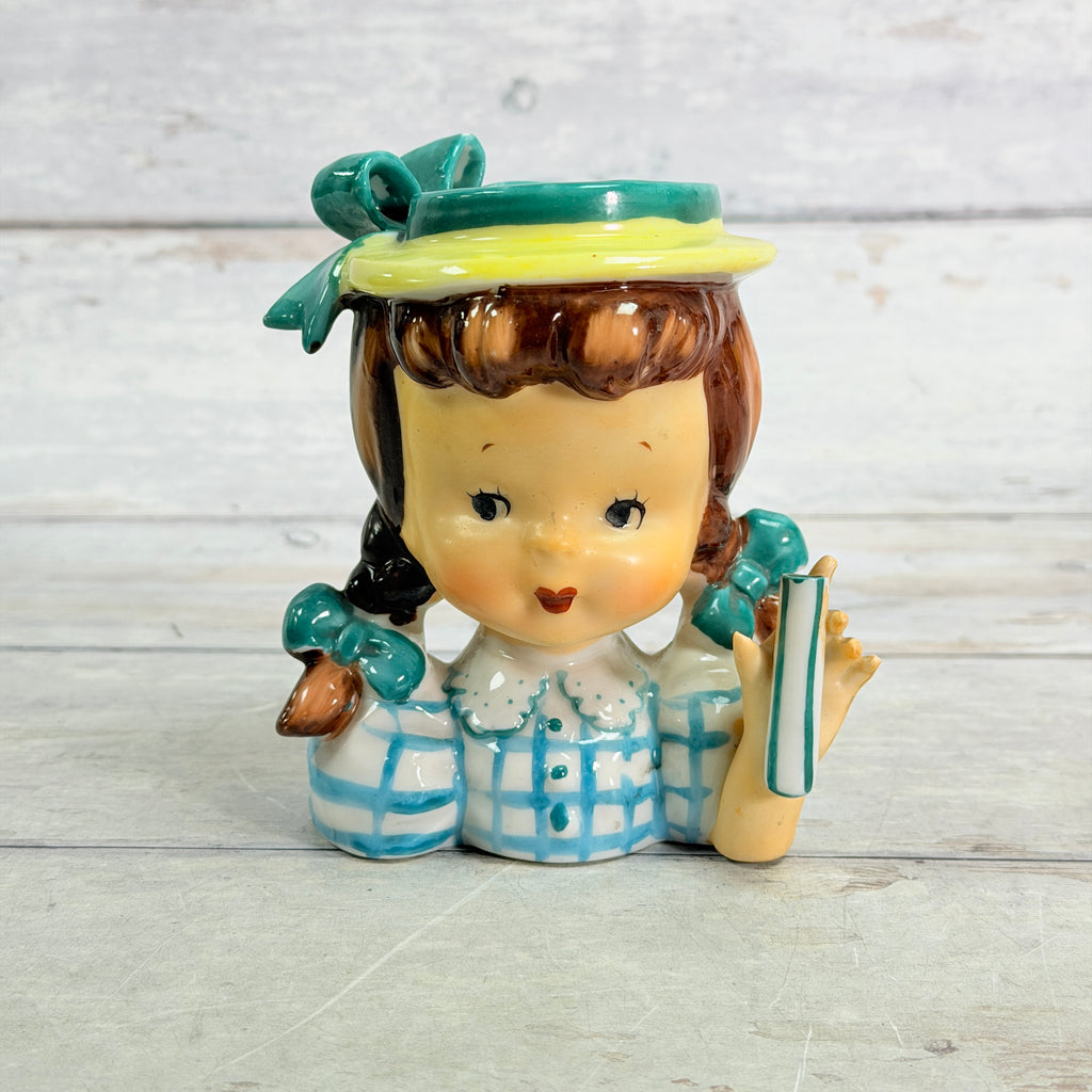 Front showing teal hat, pigtails and blue checked blouse